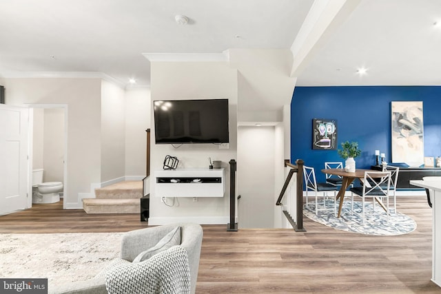 living room with ornamental molding and hardwood / wood-style flooring