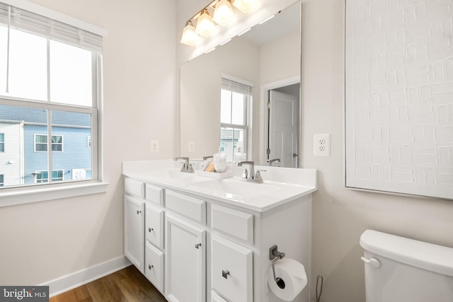 bathroom with vanity, hardwood / wood-style flooring, toilet, and a healthy amount of sunlight