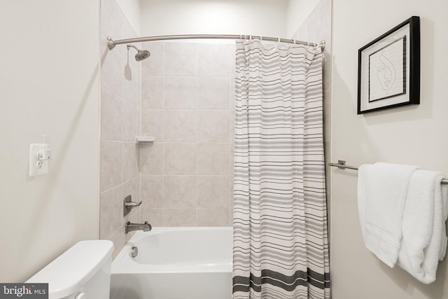 bathroom featuring shower / bath combo and toilet