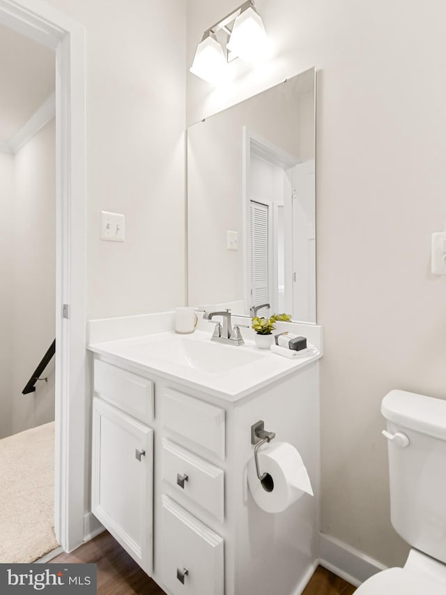 bathroom featuring vanity and toilet