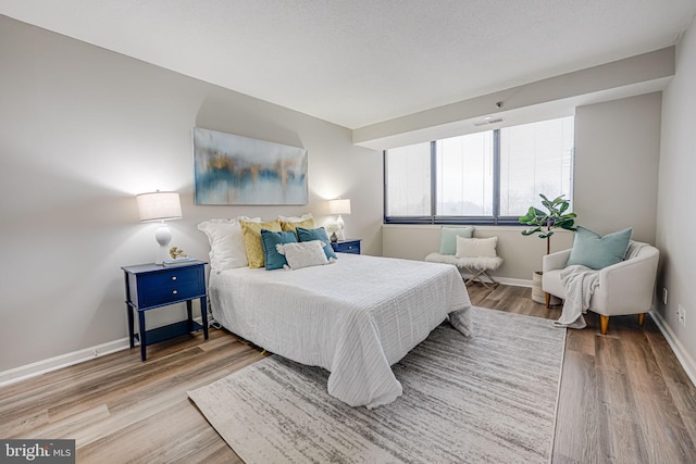 bedroom featuring hardwood / wood-style floors and a textured ceiling