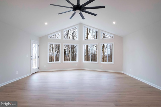 unfurnished living room featuring ceiling fan, light wood-type flooring, and high vaulted ceiling