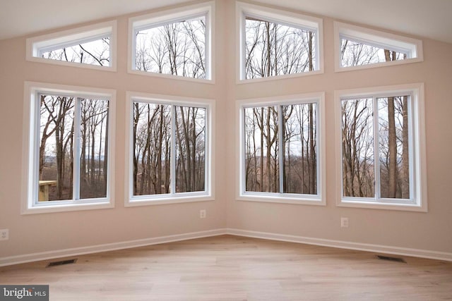 unfurnished sunroom with lofted ceiling