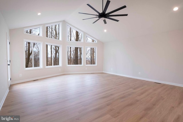 unfurnished living room featuring ceiling fan, vaulted ceiling, and light hardwood / wood-style flooring