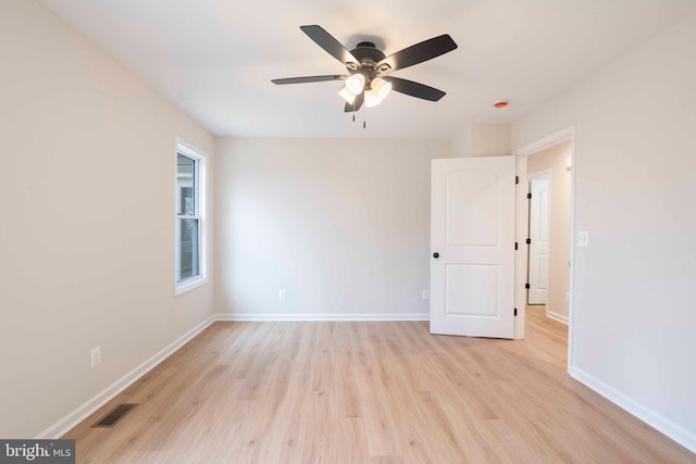 spare room featuring ceiling fan and light wood-type flooring