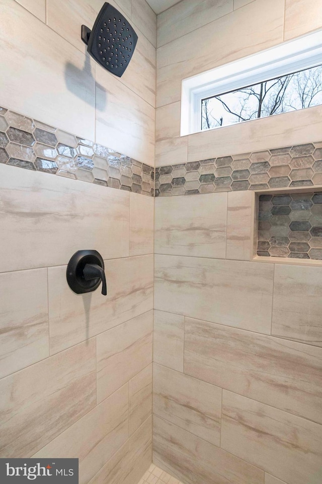 bathroom with a tile shower