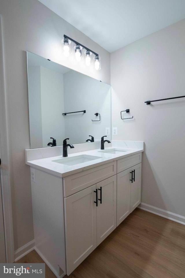 bathroom with hardwood / wood-style floors and vanity