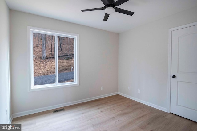 empty room featuring ceiling fan and light hardwood / wood-style floors