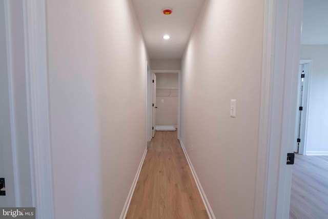 hallway with light hardwood / wood-style flooring