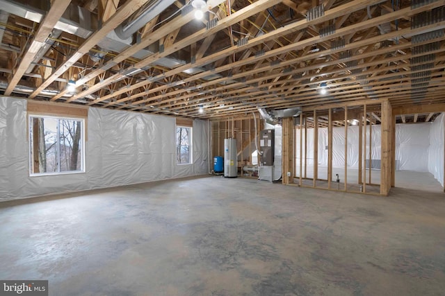 basement featuring heating unit and water heater