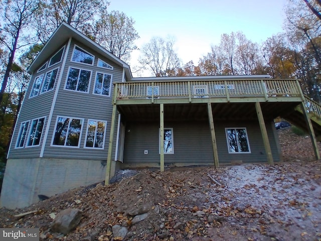 back of house with a wooden deck