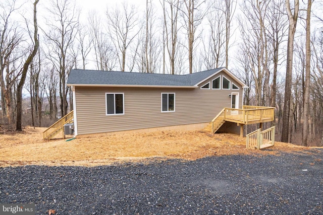 view of property exterior featuring cooling unit and a deck