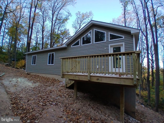 back of house featuring a deck