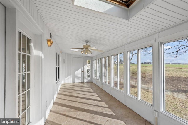 unfurnished sunroom with ceiling fan