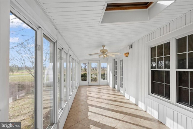 unfurnished sunroom with ceiling fan and lofted ceiling