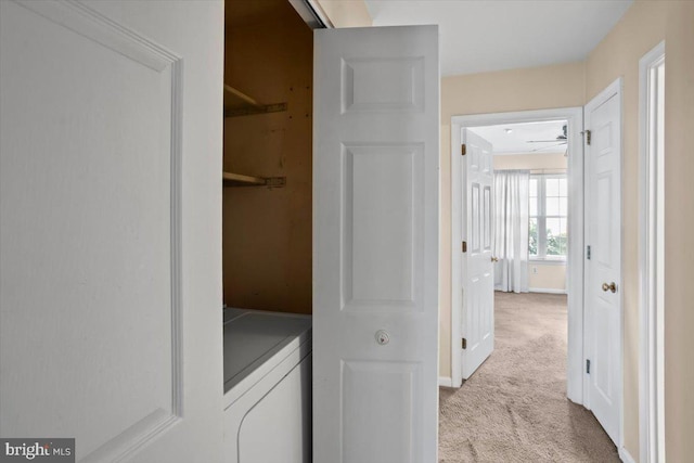 laundry area with ceiling fan, washing machine and dryer, and light carpet