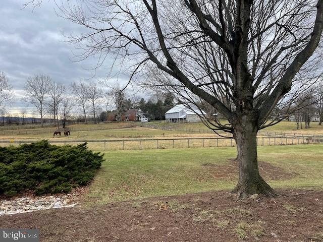 view of yard with a rural view