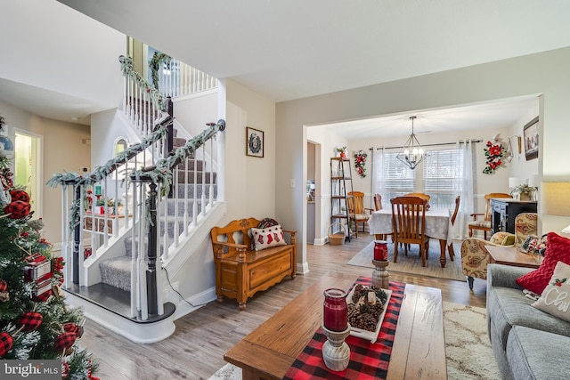 living room featuring light hardwood / wood-style floors and a notable chandelier