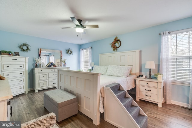 bedroom featuring ceiling fan and dark wood-type flooring