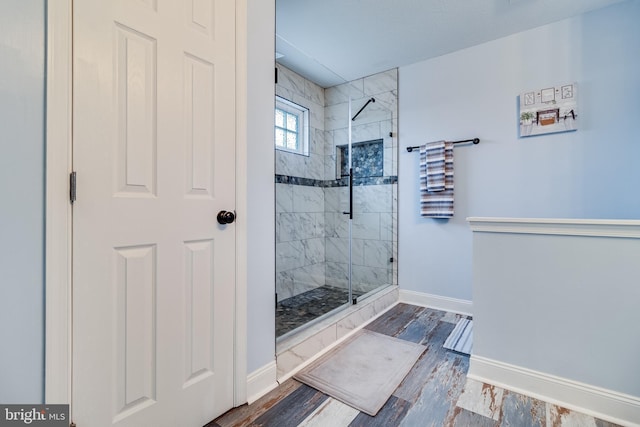 bathroom featuring hardwood / wood-style flooring and walk in shower