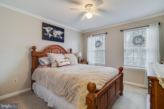 carpeted bedroom with ceiling fan and ornamental molding