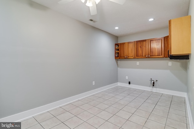 clothes washing area with cabinets, ceiling fan, light tile patterned flooring, and hookup for a gas dryer