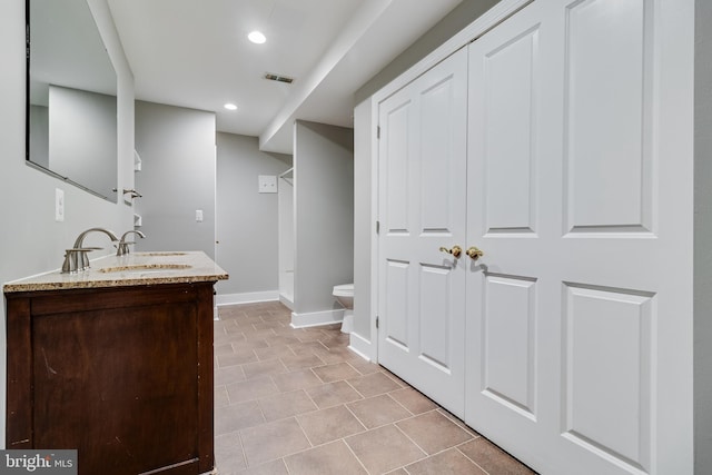 bathroom with vanity and toilet