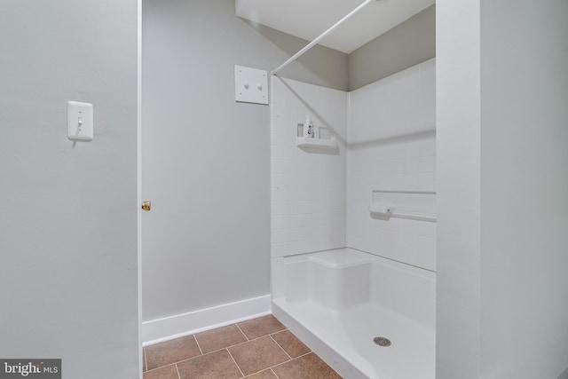 bathroom with a shower and tile patterned floors