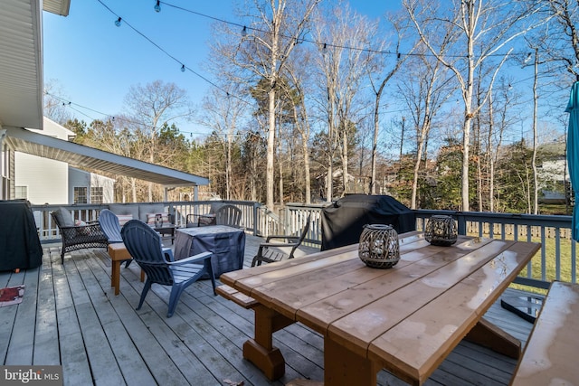 wooden deck with a grill