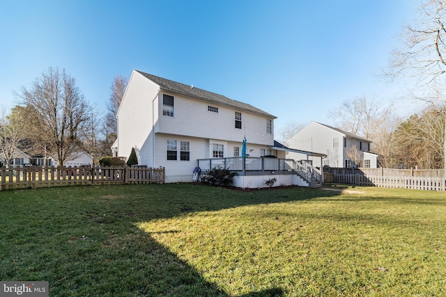 back of house featuring a deck and a yard