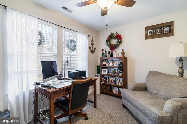 carpeted office space featuring ceiling fan