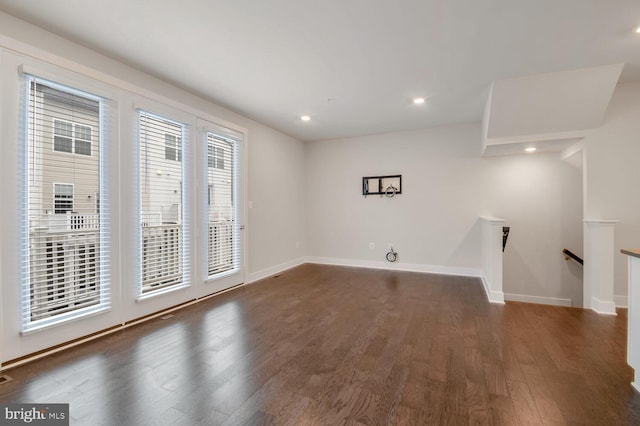 unfurnished living room featuring dark wood-type flooring