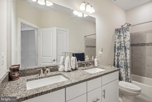 full bathroom featuring toilet, shower / bath combo, and vanity