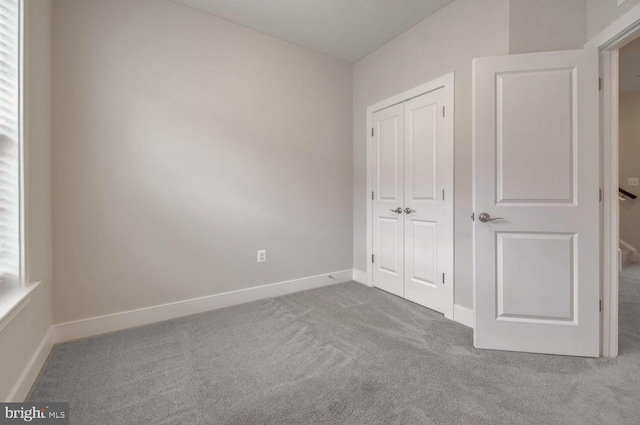 unfurnished bedroom with carpet flooring and a closet