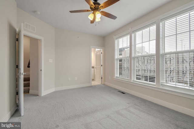 carpeted spare room with ceiling fan