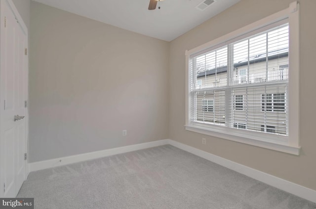 carpeted spare room with ceiling fan