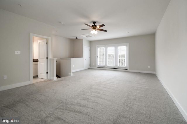 empty room with light colored carpet and ceiling fan