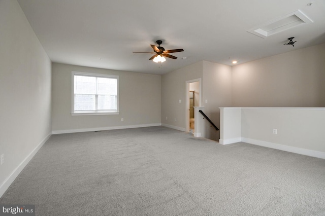 carpeted spare room featuring ceiling fan