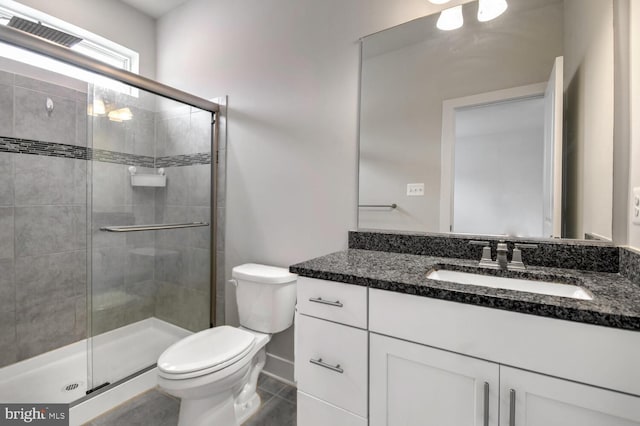 bathroom with tile patterned flooring, an enclosed shower, vanity, and toilet