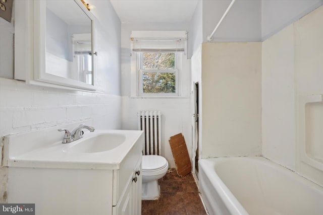 full bathroom with radiator heating unit, tile patterned floors, bathing tub / shower combination, toilet, and vanity