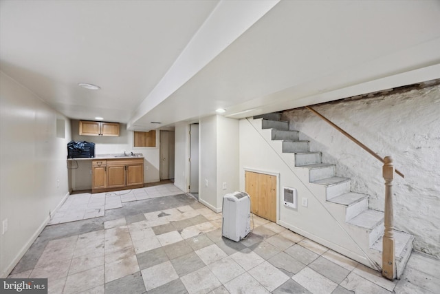 basement with heating unit and sink