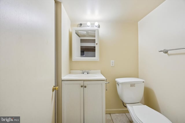 bathroom with tile patterned floors, vanity, and toilet