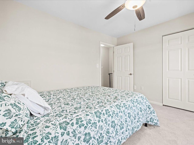 bedroom featuring light carpet, a closet, and ceiling fan