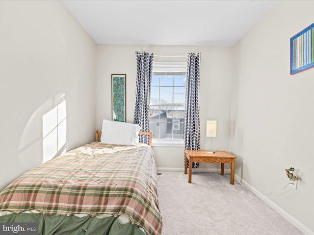 bedroom featuring light colored carpet