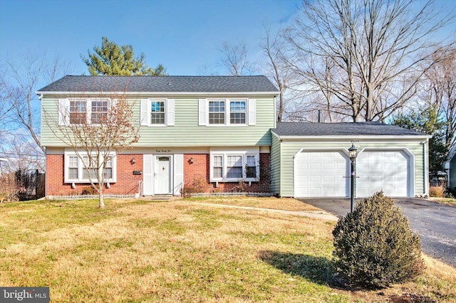 view of front of property with a garage and a front lawn