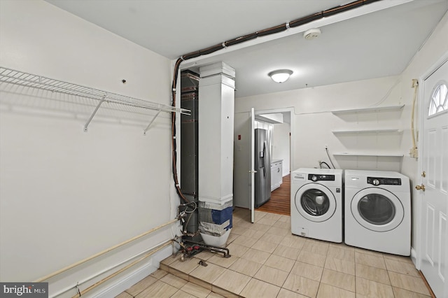 clothes washing area featuring separate washer and dryer