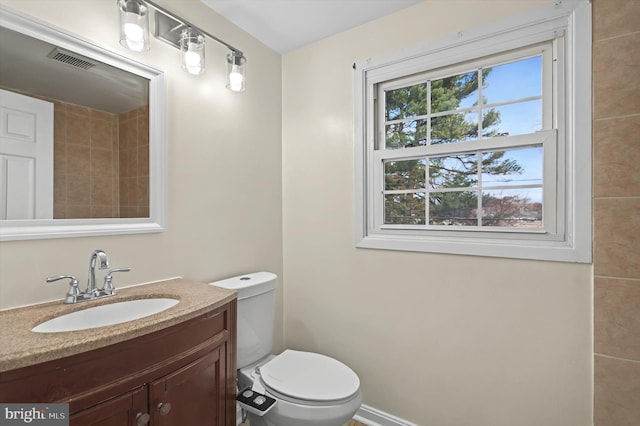 bathroom with vanity and toilet