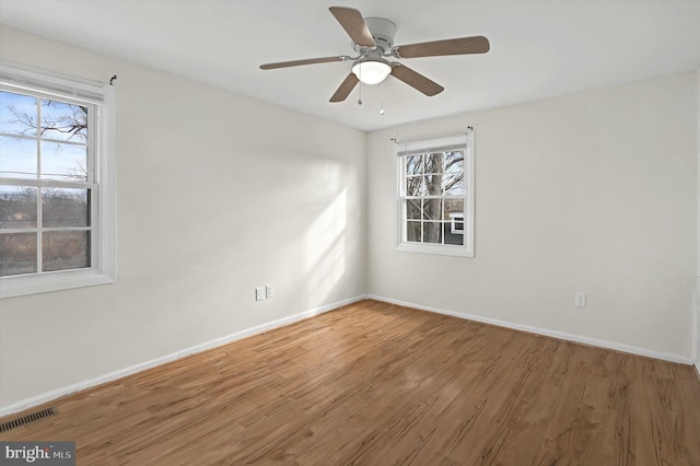 unfurnished room featuring ceiling fan and wood-type flooring