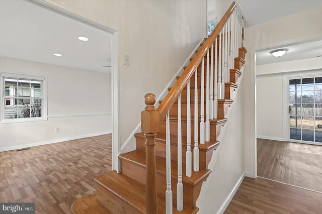 stairs featuring hardwood / wood-style flooring