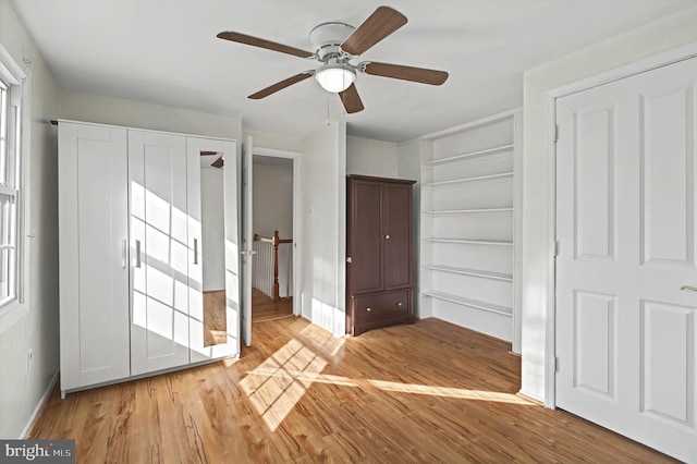 unfurnished bedroom with light hardwood / wood-style flooring and ceiling fan